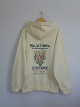 Load image into Gallery viewer, Light yellow Be Kind hooded sweatshirt with a floral design that includes embroidery and screenprinting elements