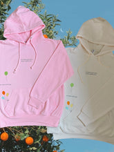 Load image into Gallery viewer, there is power in letting go hoodie in pink and cream colorways. orange tree in the background