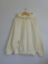 Load image into Gallery viewer, Light yellow Be Kind hooded sweatshirt with a floral design that includes embroidery and screenprinting elements
