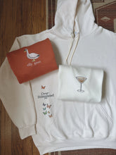 Load image into Gallery viewer, overstimulated hoodie with a butterfly design on the front pocket, silly goose embroidered crewneck, and espresso martini crewneck
