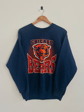 Load image into Gallery viewer, Navy blue sweatshirt with Chicago Bears logo on a wooden hanger against a light gray background
